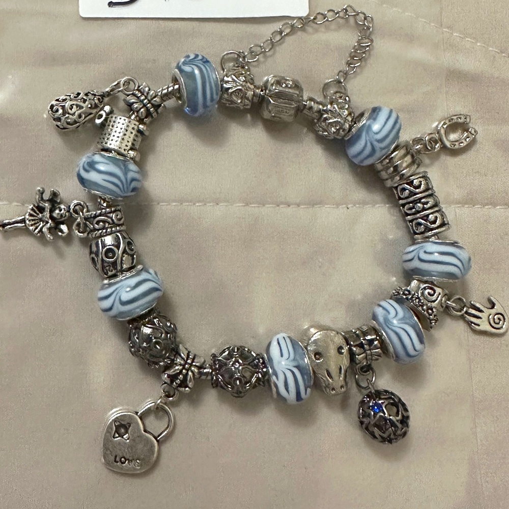Handmade – NWOT – 925 SS plated charm bracelet. Lt Blue beads. Variety charms.